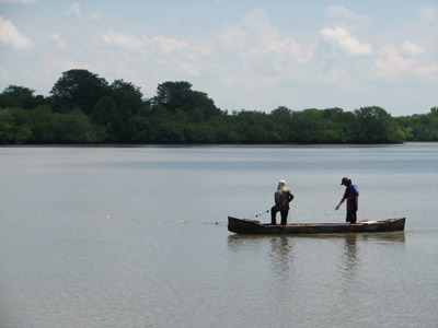 fishing from a dugout canoe. Bahia del Sol, El Salvador
